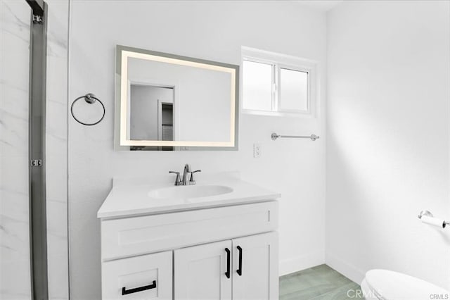 bathroom featuring hardwood / wood-style floors, toilet, vanity, and an enclosed shower