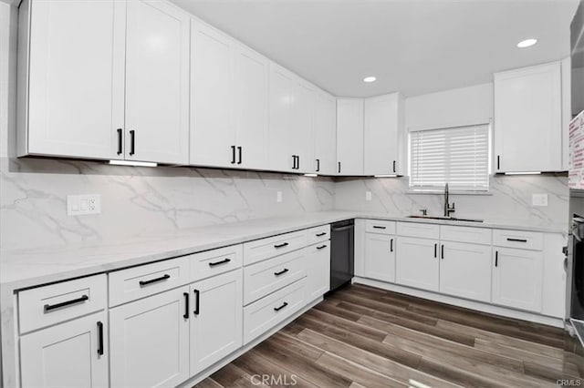 kitchen featuring white cabinetry, tasteful backsplash, sink, dark wood-type flooring, and dishwashing machine