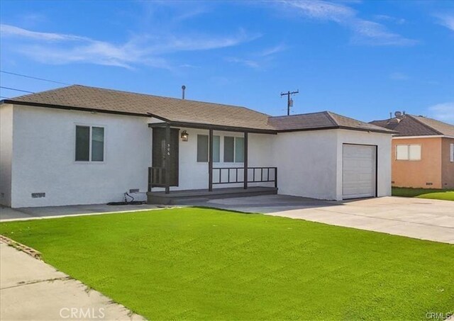 ranch-style home with a garage and a front lawn