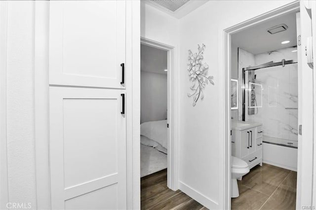 bathroom with hardwood / wood-style floors, toilet, and vanity