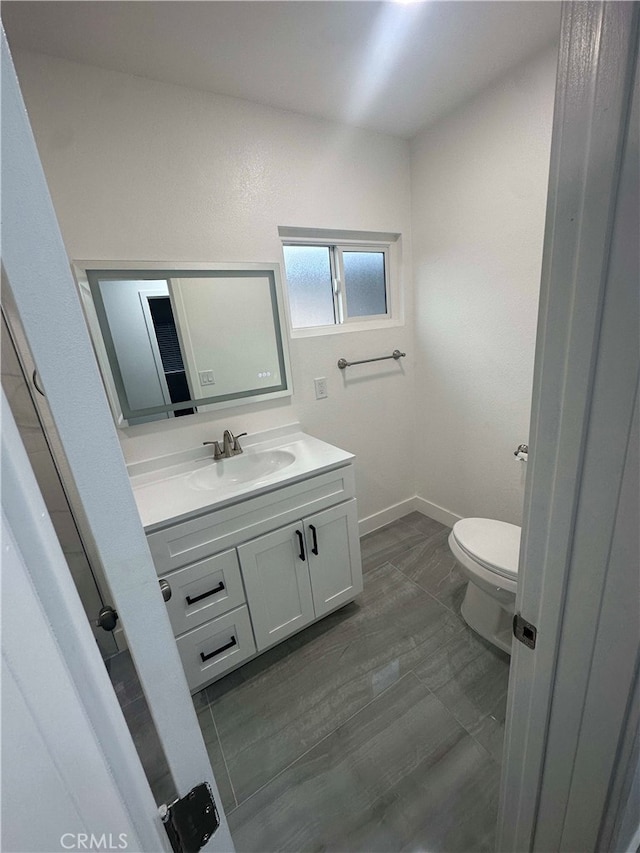 bathroom with toilet and vanity