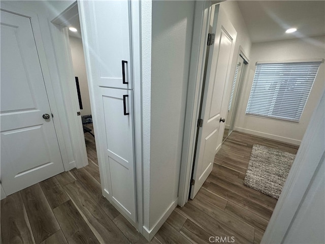 hallway with dark hardwood / wood-style floors