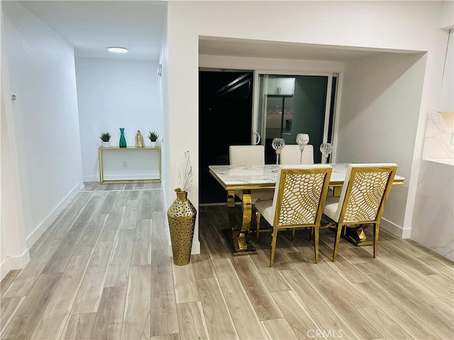 dining space featuring light wood-type flooring