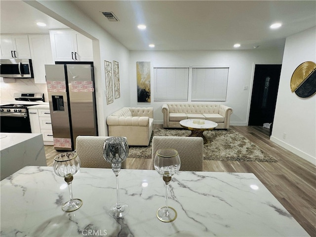 living room with light hardwood / wood-style flooring