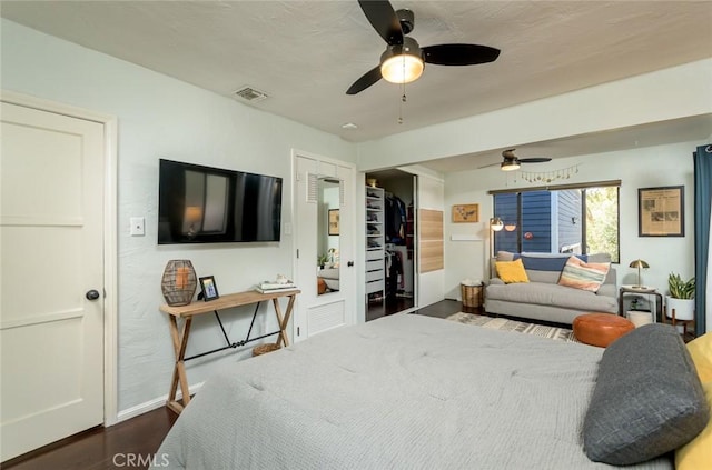 bedroom with ceiling fan and dark wood-type flooring