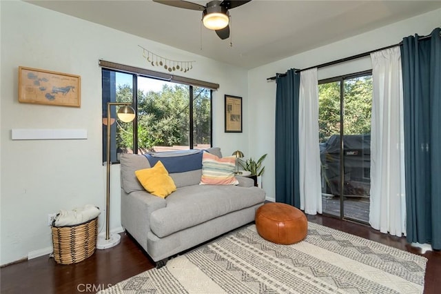 sitting room with a wealth of natural light, dark hardwood / wood-style flooring, and ceiling fan