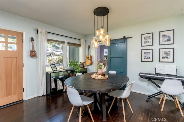 dining room featuring a barn door and dark hardwood / wood-style flooring