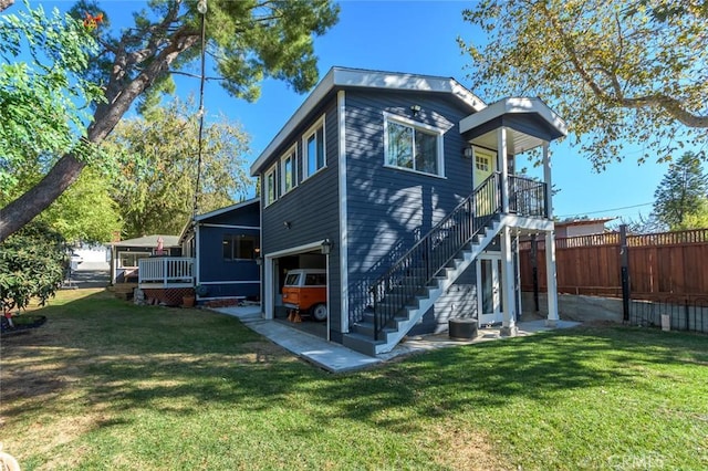 back of property with a yard and a garage