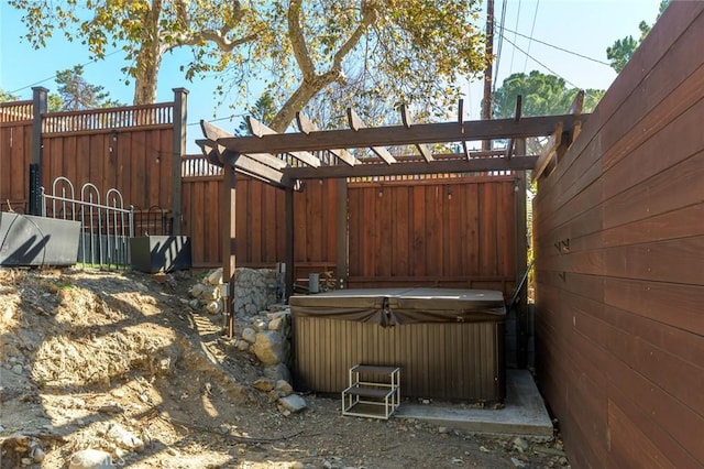 view of yard featuring a pergola and a hot tub