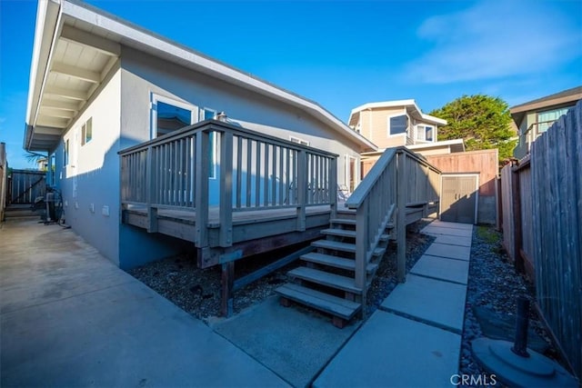 rear view of house with a wooden deck