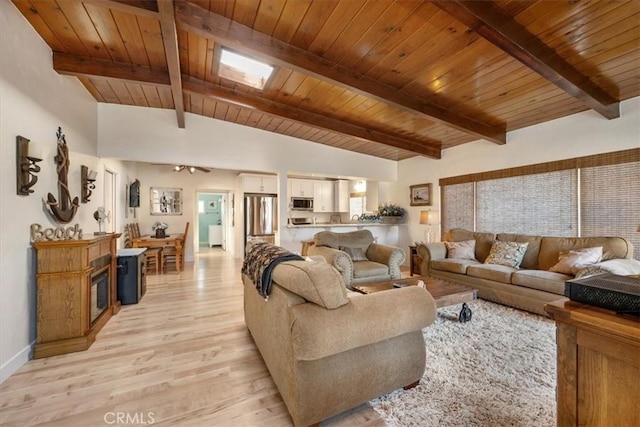 living room featuring vaulted ceiling with beams, light hardwood / wood-style floors, and wood ceiling