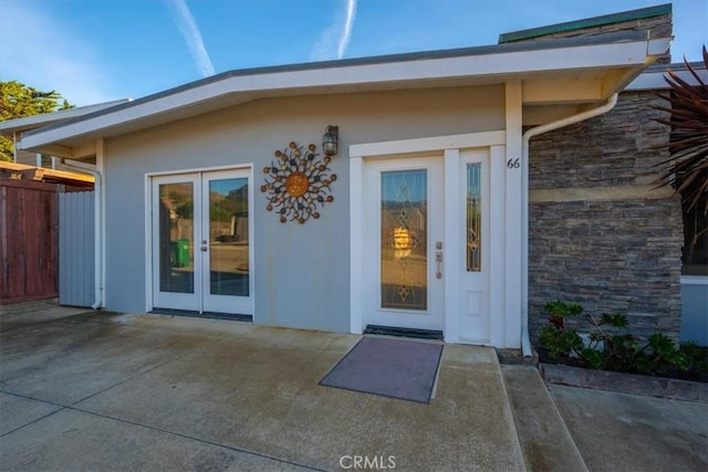 entrance to property with a patio and french doors