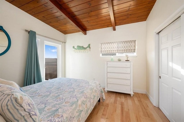 bedroom with beam ceiling, wooden ceiling, a closet, and light hardwood / wood-style floors