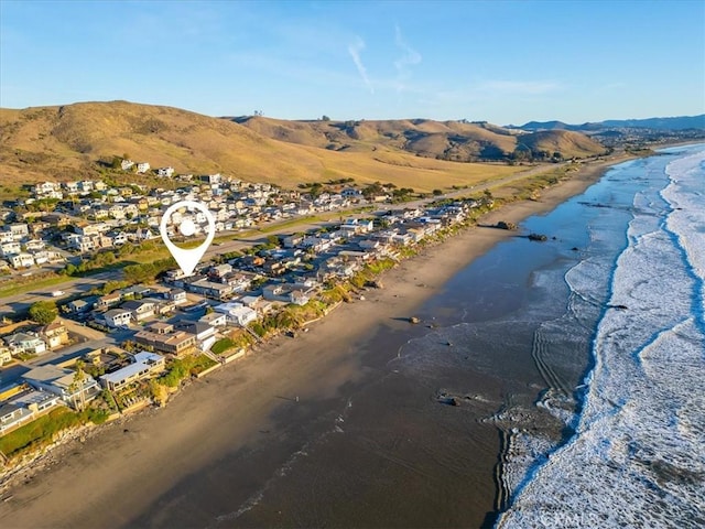 aerial view with a beach view and a water and mountain view