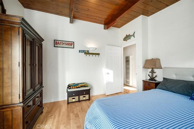 bedroom with beam ceiling, light wood-type flooring, and wood ceiling