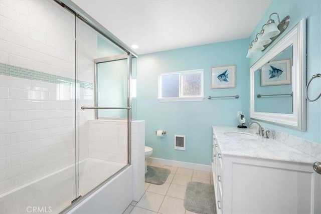 full bathroom with vanity, bath / shower combo with glass door, tile patterned flooring, toilet, and heating unit