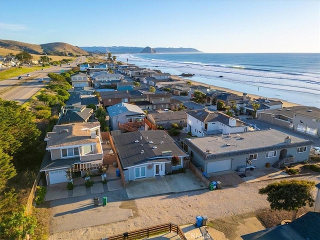 bird's eye view featuring a water and mountain view and a beach view