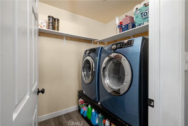 laundry area with hardwood / wood-style flooring and washer and clothes dryer