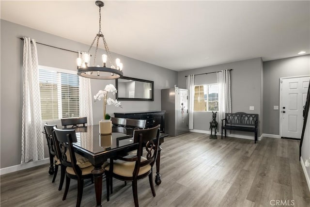 dining space featuring a chandelier, hardwood / wood-style flooring, and plenty of natural light