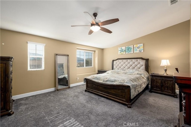 bedroom featuring multiple windows, ceiling fan, dark carpet, and vaulted ceiling