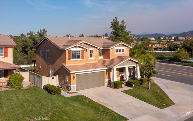 view of front of property featuring a garage and a front yard