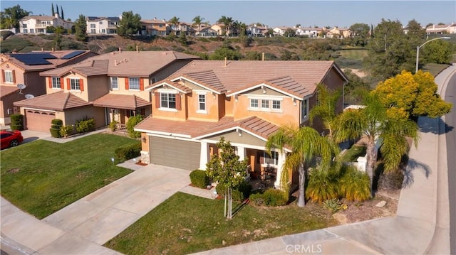 view of front of home with a garage and a front yard