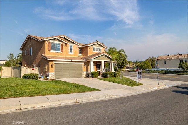 craftsman inspired home featuring a garage and a front lawn