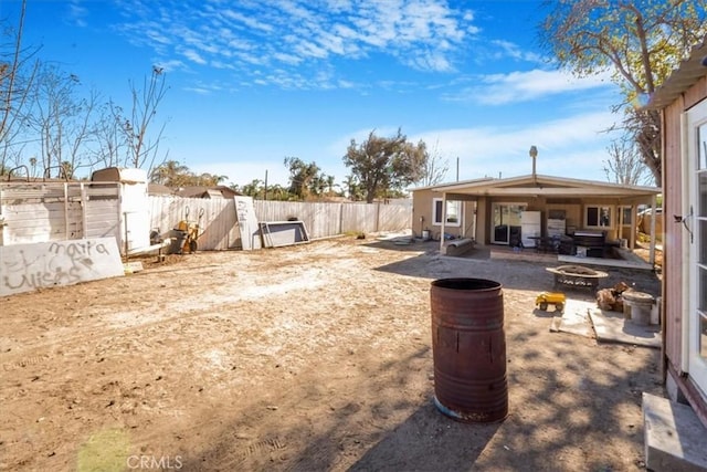 view of yard with a fire pit