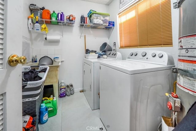 laundry room featuring separate washer and dryer, light tile patterned floors, and water heater