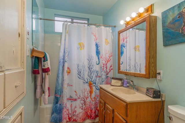 full bathroom featuring shower / bath combination with curtain, toilet, and vanity