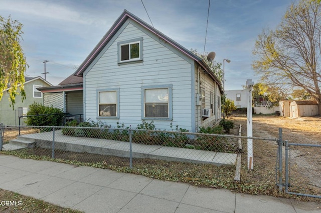 bungalow-style house featuring a shed