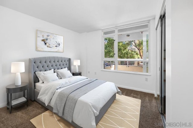 bedroom featuring dark carpet and a closet