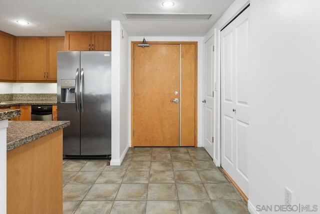 kitchen with stainless steel fridge with ice dispenser and light tile patterned floors