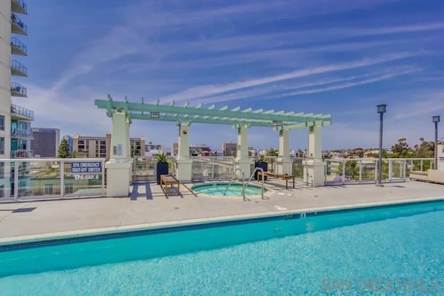 view of pool featuring a pergola and a community hot tub