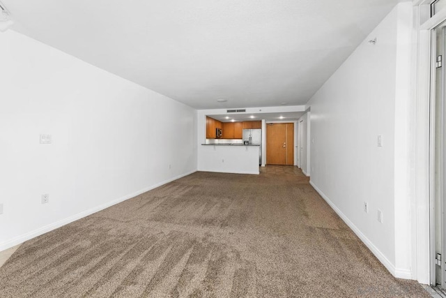 unfurnished living room with carpet floors