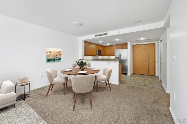 dining room with light colored carpet