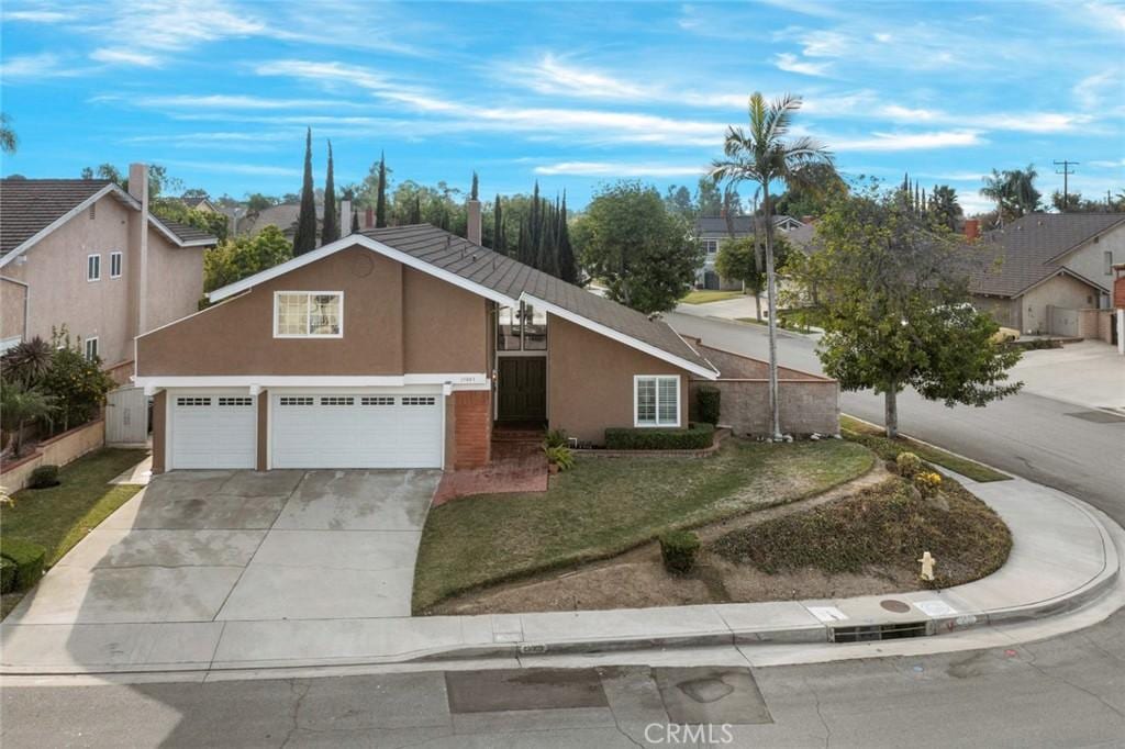 view of front of property with a front lawn and a garage