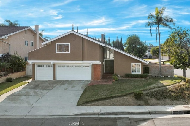 view of front of house featuring a garage and a front lawn