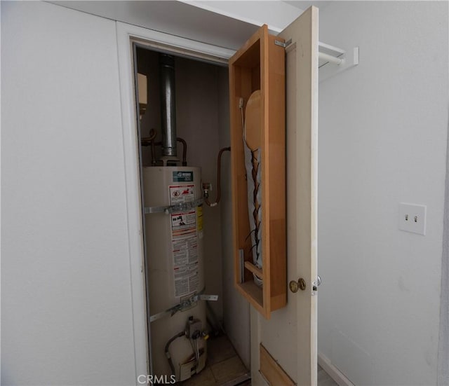 utility room featuring strapped water heater