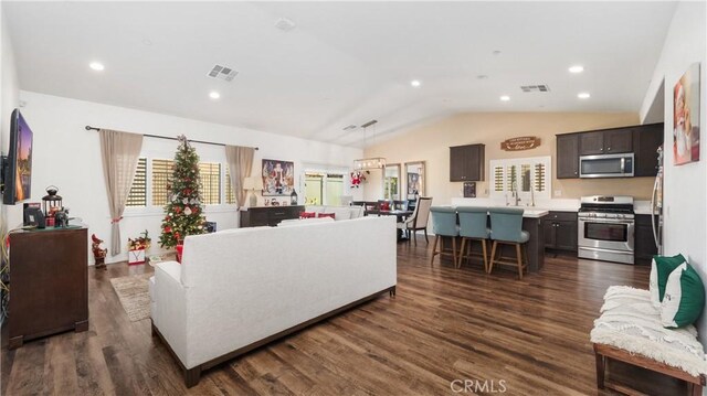 living room with dark hardwood / wood-style floors and vaulted ceiling