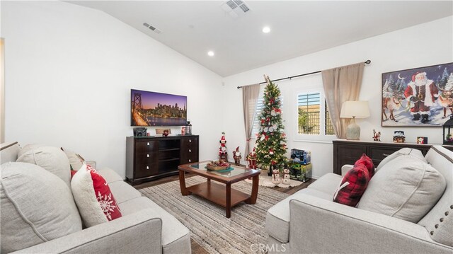 living room with vaulted ceiling and hardwood / wood-style flooring