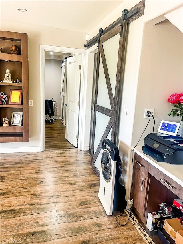 interior space featuring light hardwood / wood-style floors and a barn door