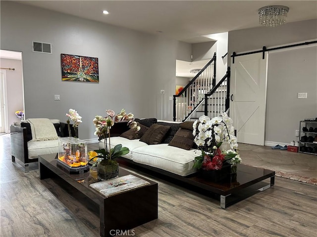 living room with wood-type flooring and a barn door