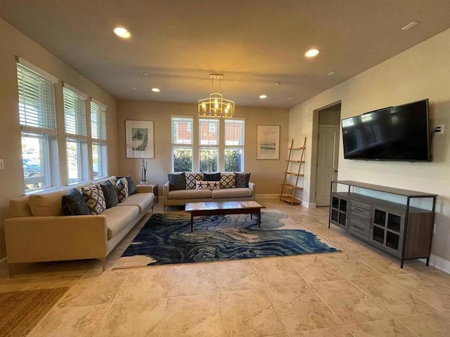 living room with a notable chandelier and light tile patterned floors