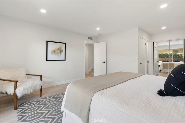 bedroom featuring access to exterior and light hardwood / wood-style floors