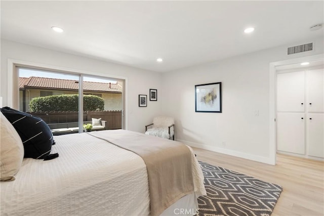 bedroom featuring access to exterior and light hardwood / wood-style flooring