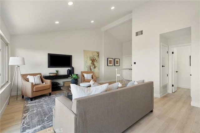 living room with high vaulted ceiling and light wood-type flooring