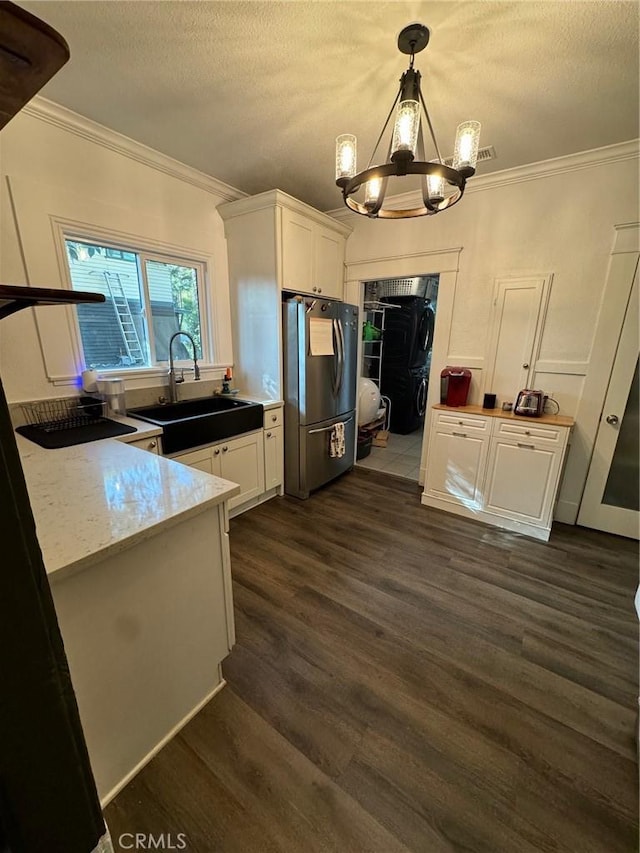 1355 N Gordon St, Pomona, CA 91768 - kitchen featuring freestanding refrigerator, a sink, a chandelier, white cabinetry, and ornamental molding