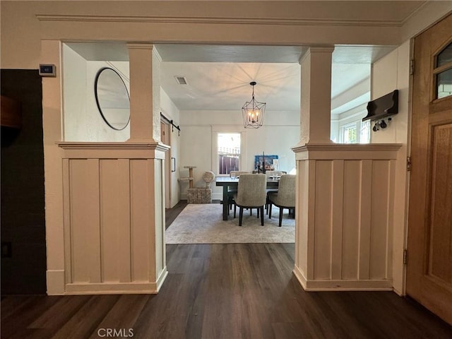 1355 N Gordon St, Pomona, CA 91768 - foyer entrance featuring a barn door, dark wood finished floors, a decorative wall, healthy amount of natural light, and a chandelier