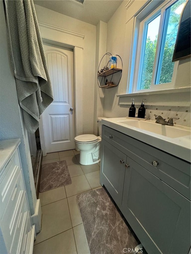 full bathroom featuring tile patterned flooring, toilet, and vanity